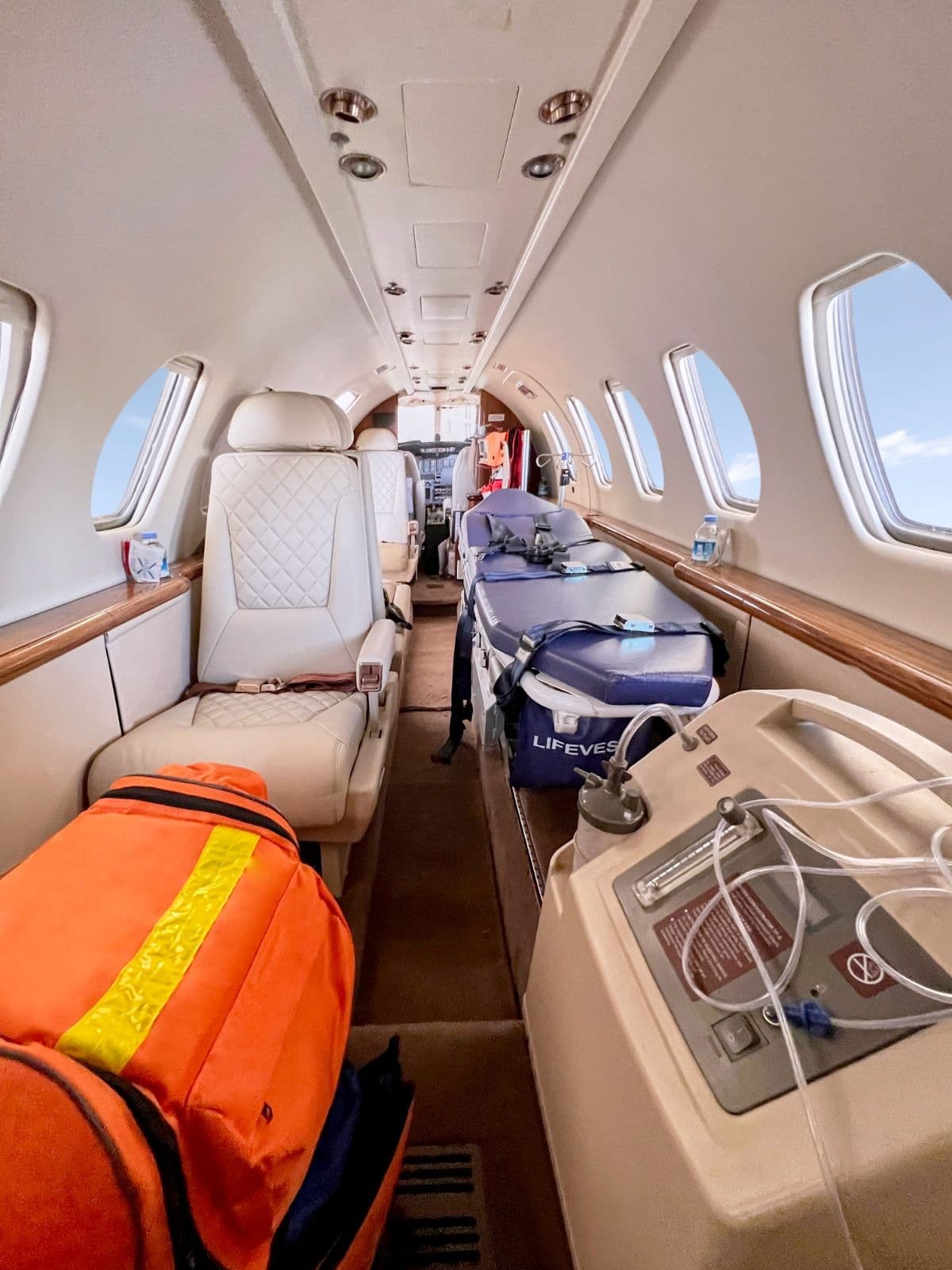 Cabin configured for a stretcher patient, with oxygen and monitoring equipment alongside