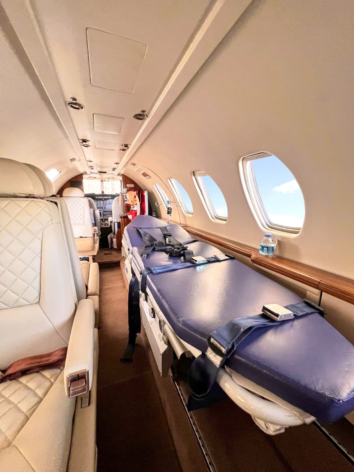 Stretcher secured along the cabin wall, with seating for accompanying persons